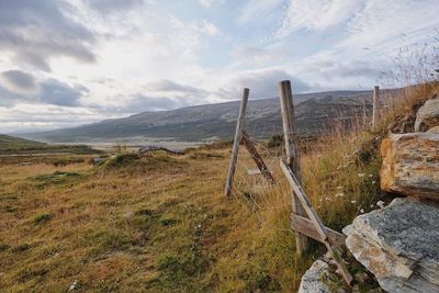 Scenic view of landscape against cloudy sky