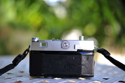 Close-up of camera on mobile phone outdoors