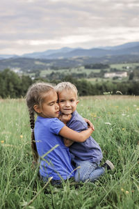 Cute boy smiling on grassy field