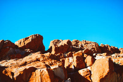 Rock formations against clear blue sky