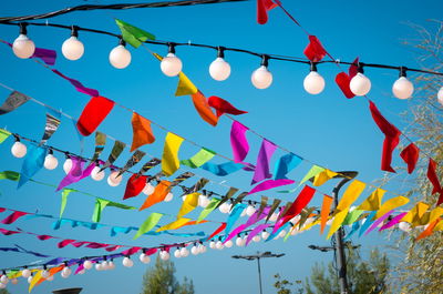 Low angle view of lanterns hanging against sky