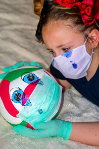 High angle view of cute girl with toy