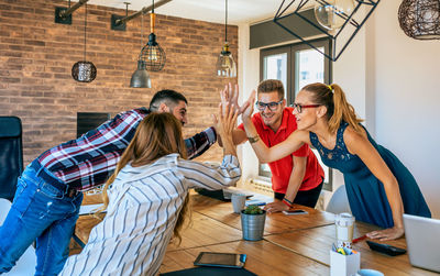 Businesspeople celebrating a success high-fiving