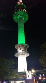 Statue of illuminated tower at night