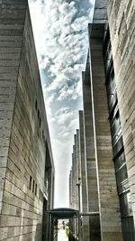Low angle view of building against cloudy sky