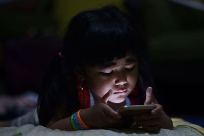 Close-up of girl using mobile phone