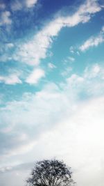 Low angle view of tree against cloudy sky