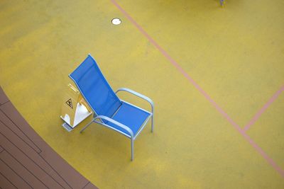 High angle view of blue chair on floor