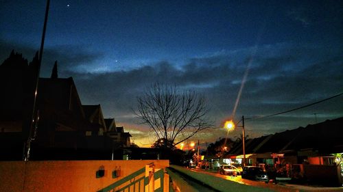 Cars on road against sky at night