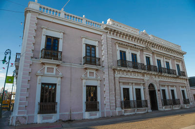 Low angle view of building against blue sky