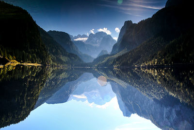 Scenic view of calm lake with mountains reflection