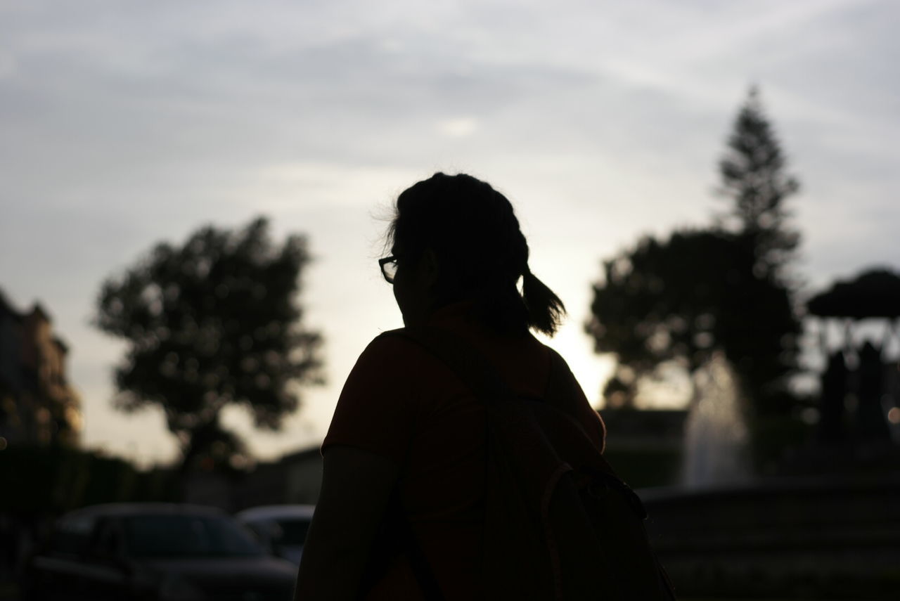 REAR VIEW OF SILHOUETTE WOMAN AGAINST SKY