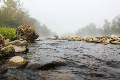 Scenic view of rocks in sea against sky