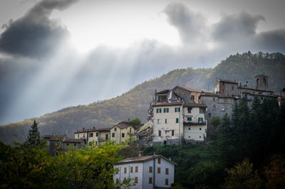 Buildings against cloudy sky