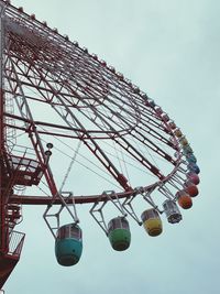 Low angle view of ferris wheel against sky