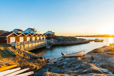 The picture displays a beautiful sunset over the harbor of an old swedish seaside cabins,