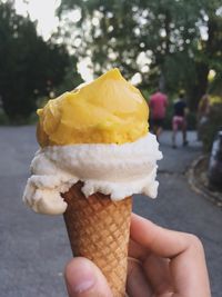 Cropped image of hand holding ice cream cone
