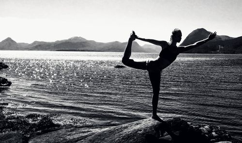 Full length of woman on sea against mountain