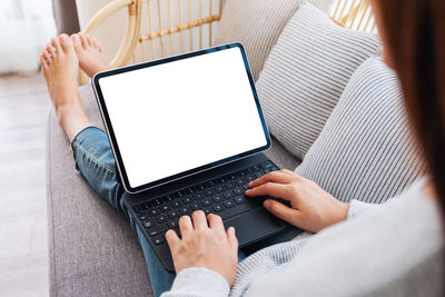 Midsection of woman using laptop