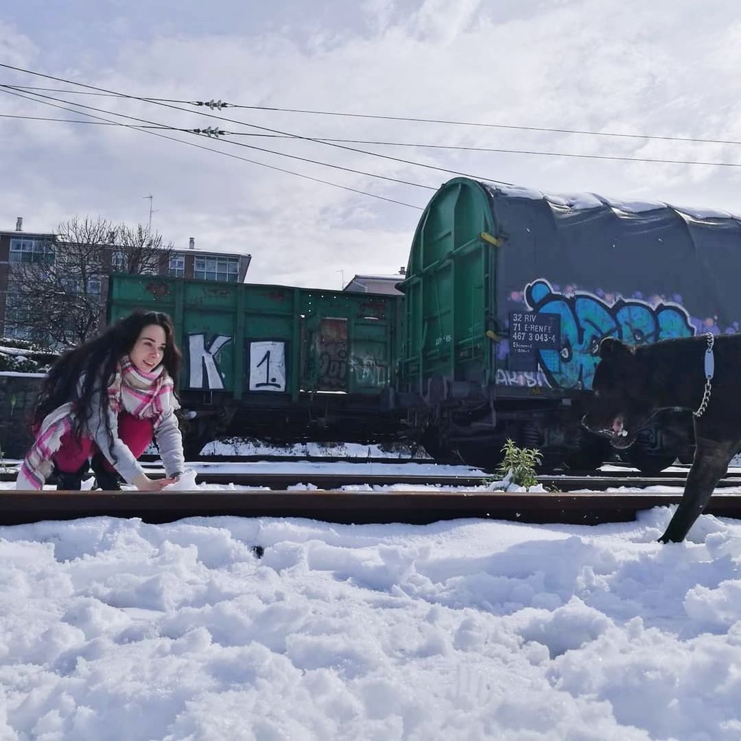 cloud - sky, sky, real people, transportation, one person, day, outdoors, mode of transport, winter, cold temperature, land vehicle, young adult, lifestyles, snow, built structure, nature, young women, building exterior, architecture