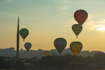 Hot air balloon flying over landscape against sky