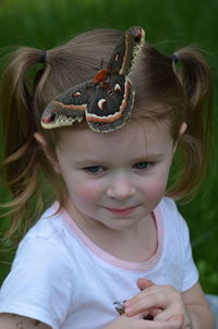 Adorable little one with cecropia moth 