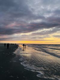 Scenic view of beach against sky during sunset