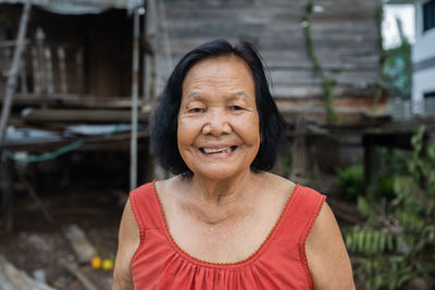 Portrait senior woman wearing mask sitting outdoors