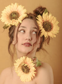 Close-up portrait of woman against white wall