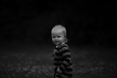 Portrait of baby girl standing on field at park