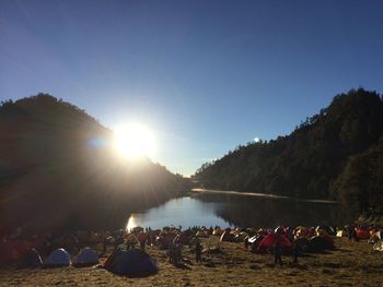 Group of people on shore against sky