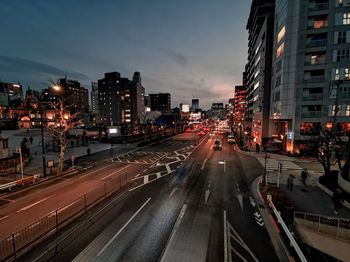 View of city street and buildings at night