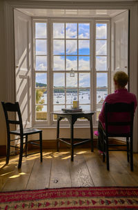 Rear view of woman sitting on chair