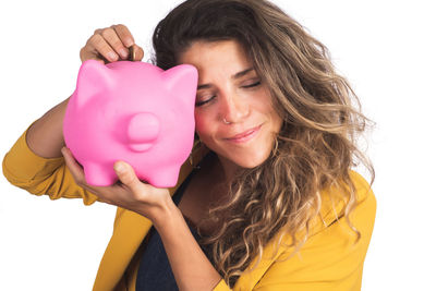 Portrait of a smiling young woman against blue background