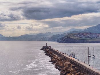 Scenic view of sea and buildings against sky