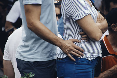 Midsection of man holding hands