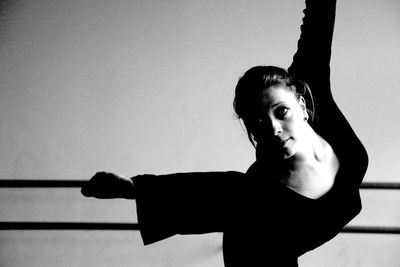 Confident woman dancing in studio