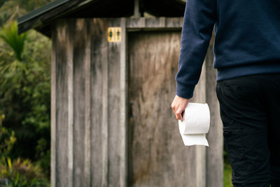 Midsection of man standing on paper