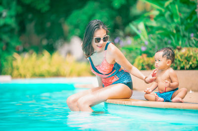 High angle view of girls sitting in swimming pool