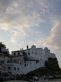 Buildings against cloudy sky