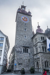 Low angle view of clock tower in city