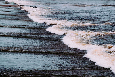 High angle view of waves rushing towards shore