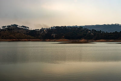 Lake calm water with mountain background at day from flat angle