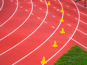 High angle view of yellow traffic cones on sports track