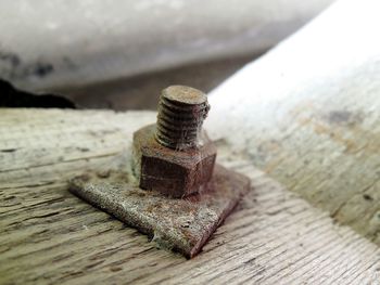 Close-up of rusty metal on wooden surface