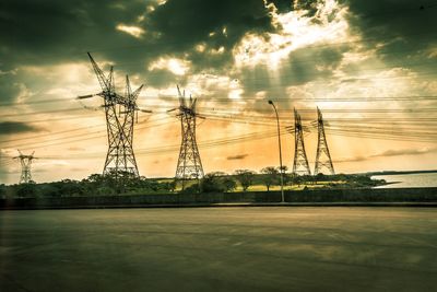 Electricity pylon on landscape against sky