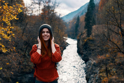 Young woman standing in park during autumn