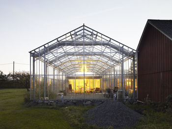 Illuminated greenhouse at dusk