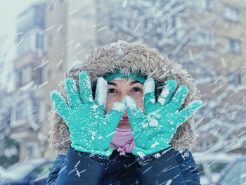 Portrait of woman with ice cream cone in snow