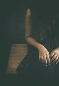 Woman in black dress with dried flowers in her hand iii